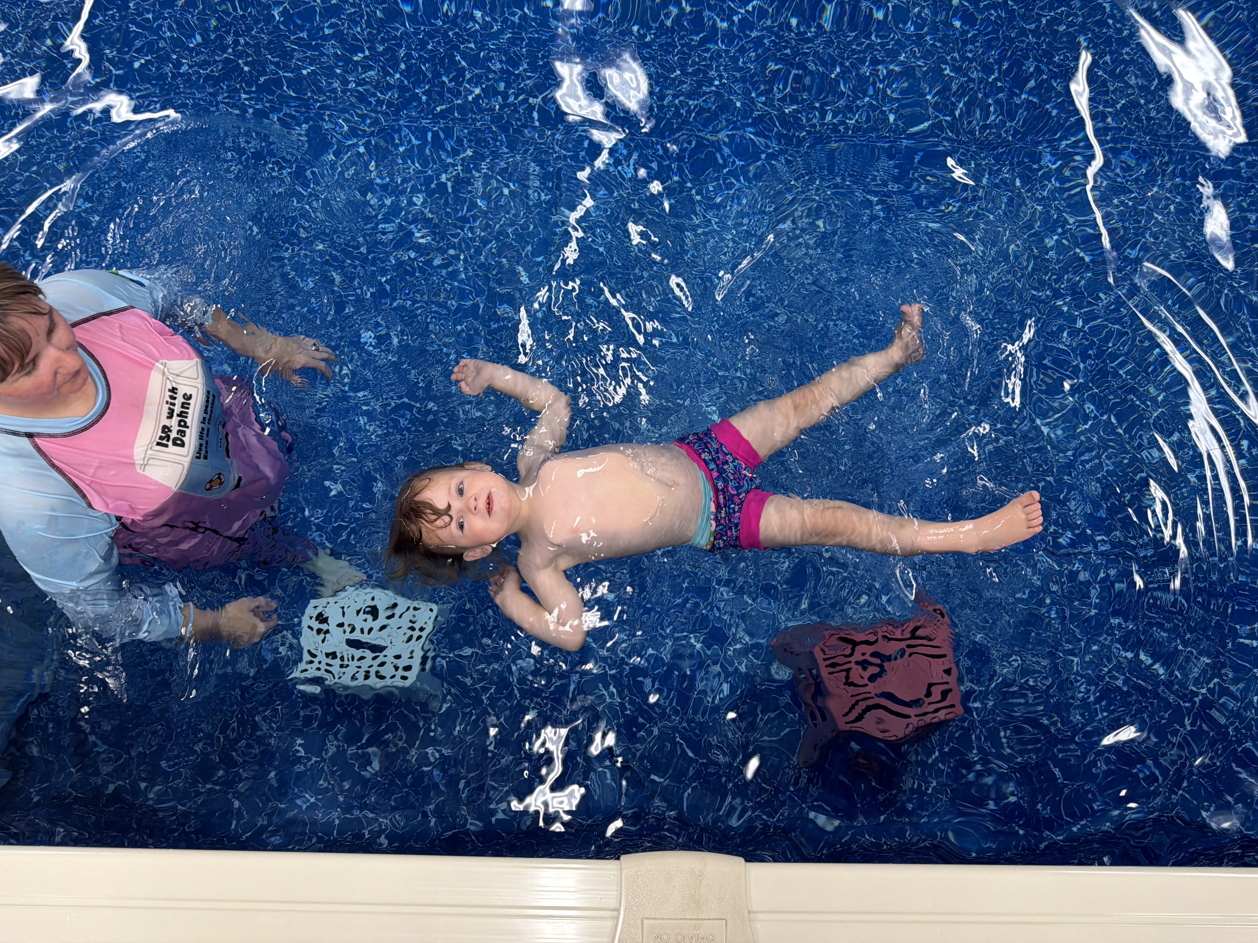 Child learning to back float during a survival swim lesson